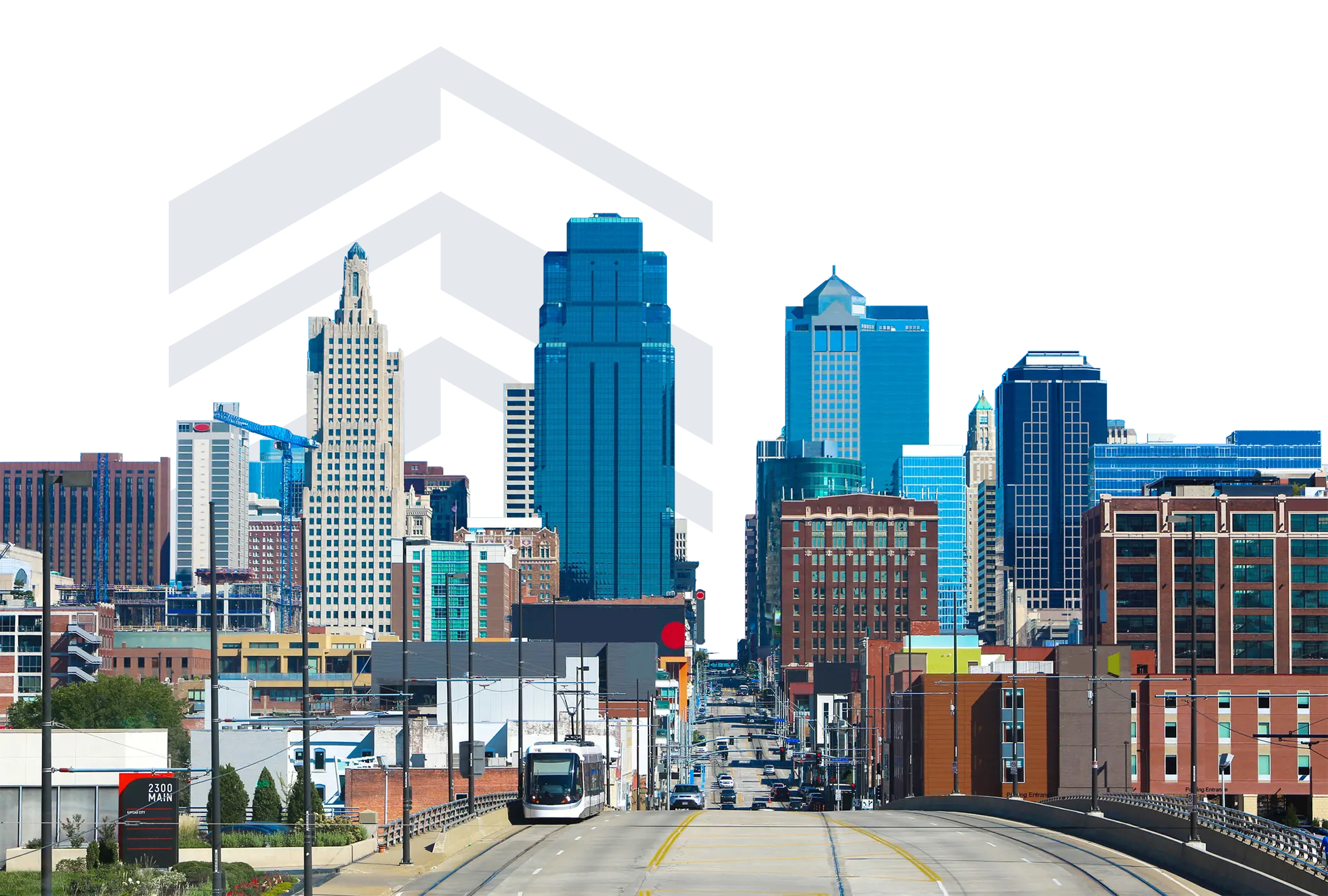 ew of downtown Kansas City from street level, with the KC Streetcar traveling down the center of the road and high-rise buildings in the background,